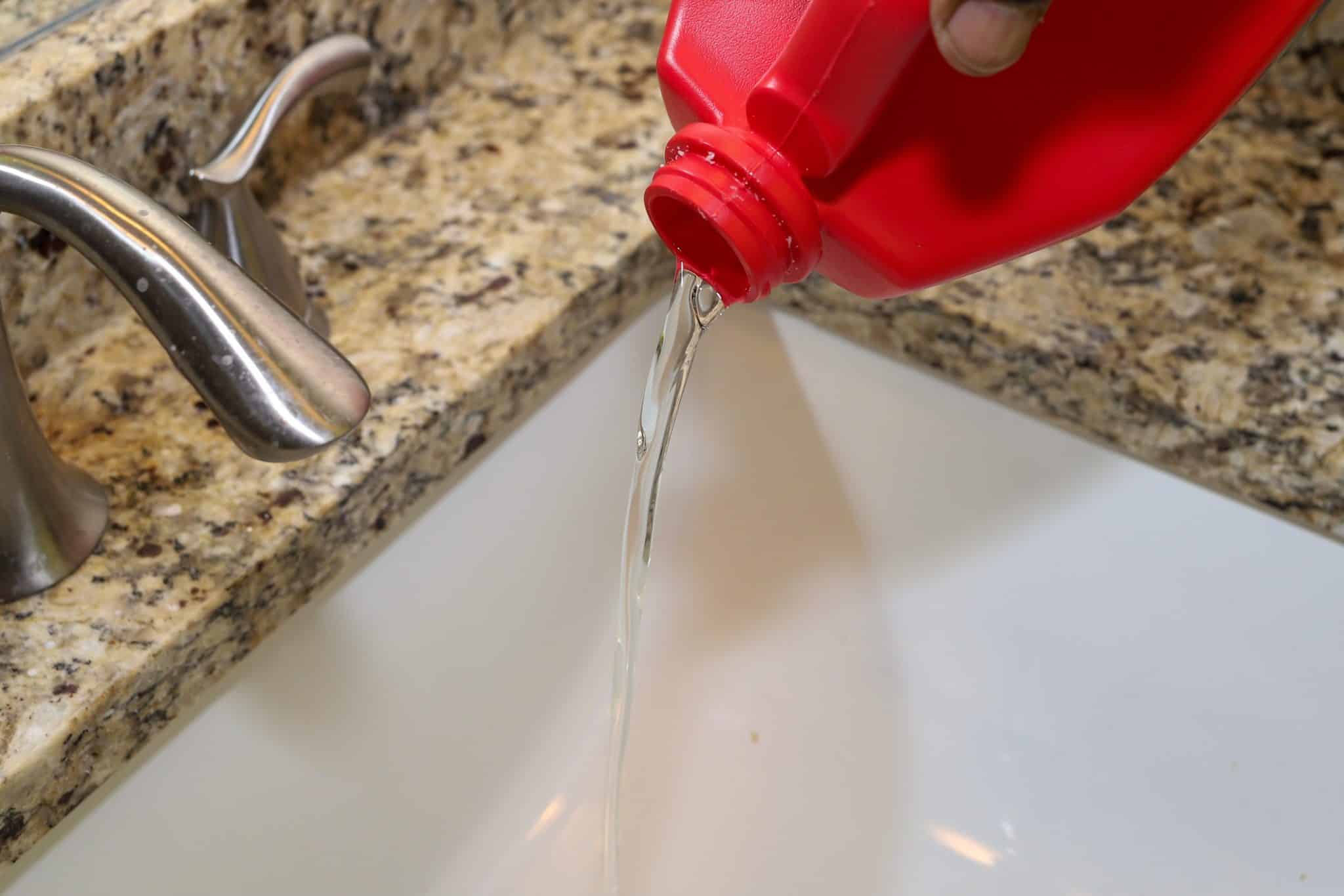 Homeowner pouring in chemical drain cleaner down pipes and unintentionally causing damage.